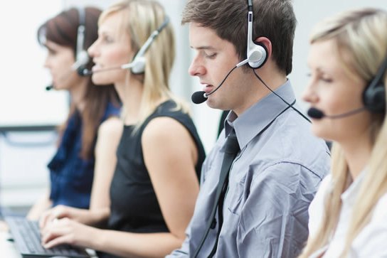 Interpreters at their desks wearing headsets